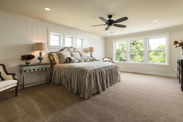 bedroom featuring ornamental molding, a ceiling fan, baseboards, and carpet floors