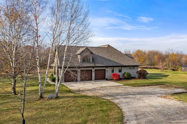 view of front of property with a garage and a front lawn