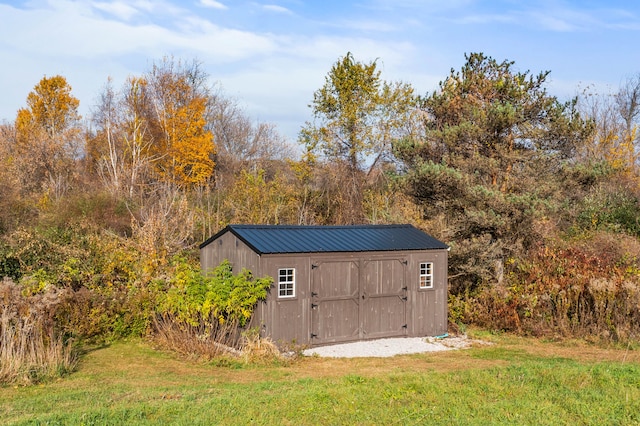 view of outbuilding featuring a lawn