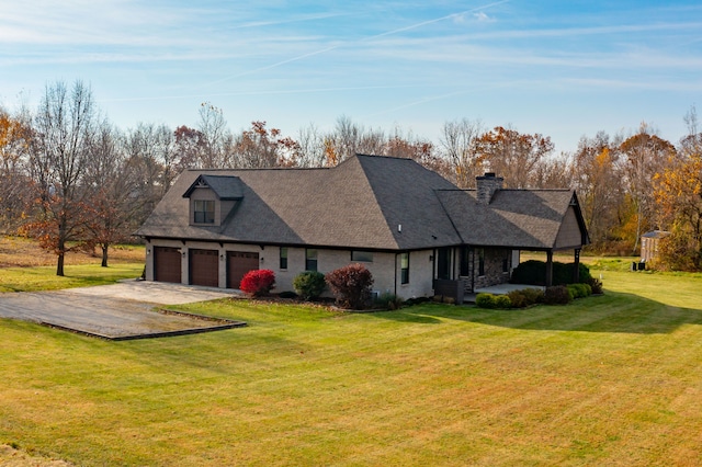 back of house featuring a garage and a yard