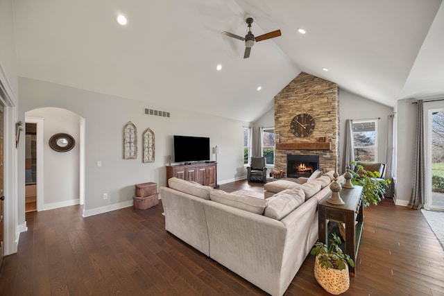 living room with ceiling fan, dark hardwood / wood-style flooring, a fireplace, and high vaulted ceiling