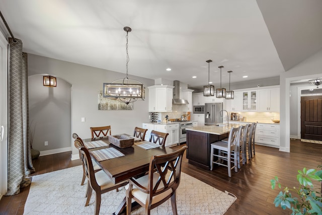 dining room featuring sink and dark hardwood / wood-style floors