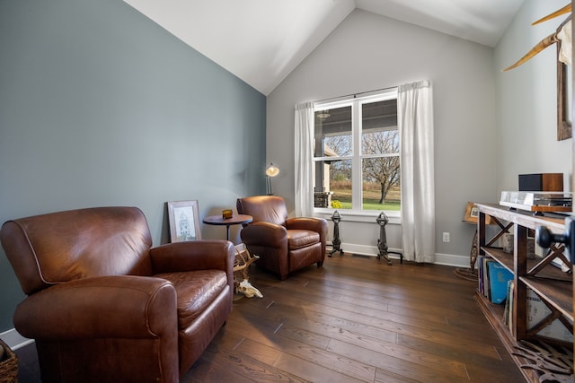 sitting room featuring dark wood-type flooring and vaulted ceiling