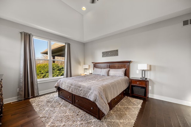 bedroom featuring high vaulted ceiling and dark hardwood / wood-style flooring