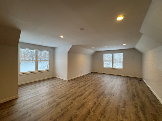 additional living space featuring dark hardwood / wood-style floors and vaulted ceiling