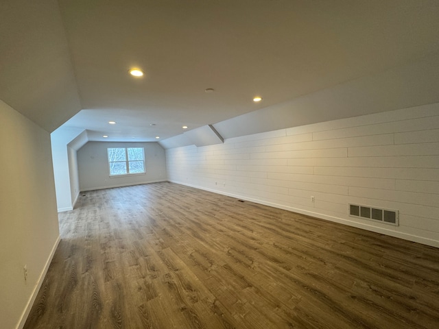 bonus room featuring dark hardwood / wood-style floors and lofted ceiling