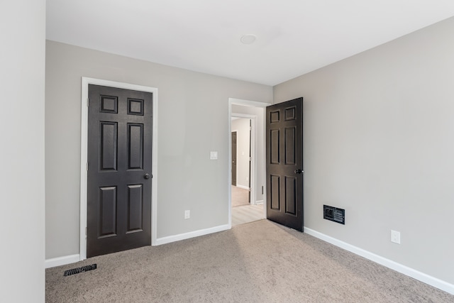 unfurnished bedroom with light colored carpet