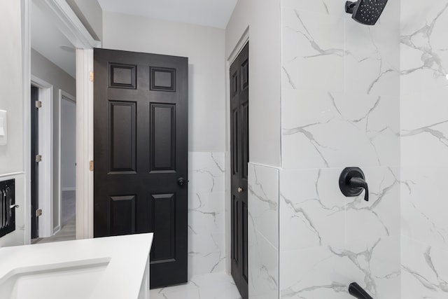 bathroom with a shower and vanity