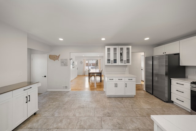 kitchen with white cabinets and appliances with stainless steel finishes