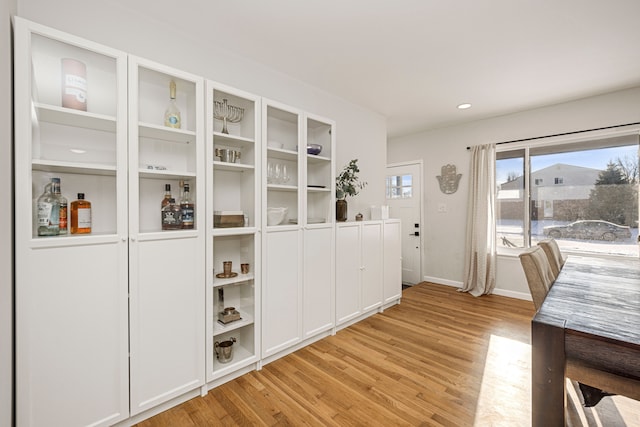 unfurnished dining area featuring light wood-type flooring