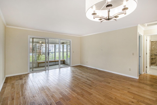 unfurnished room with hardwood / wood-style floors, crown molding, and a notable chandelier