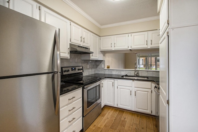 kitchen featuring crown molding, white cabinetry, stainless steel appliances, and light hardwood / wood-style flooring