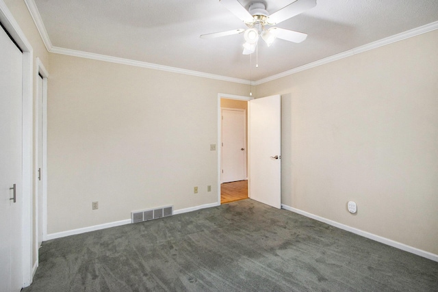 unfurnished bedroom with a textured ceiling, ceiling fan, dark carpet, and crown molding