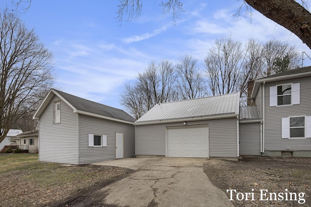 view of side of home featuring a garage and an outdoor structure