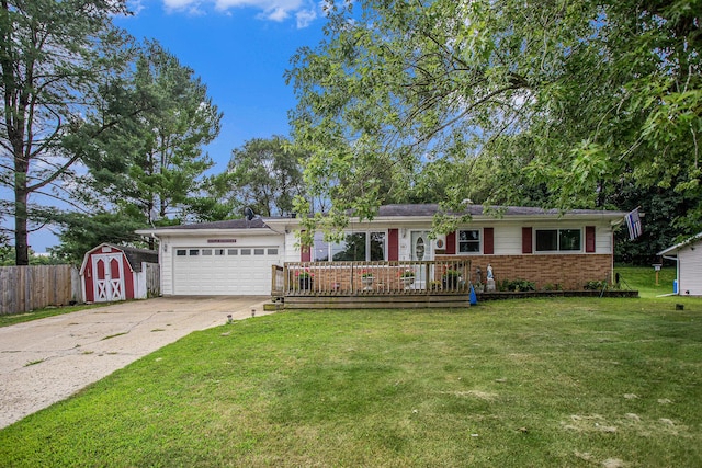 140 Wagon Wheel Ln, Battle Creek, MI 49017 - ranch-style home with a storage unit, a garage, driveway, brick siding, and a wooden deck