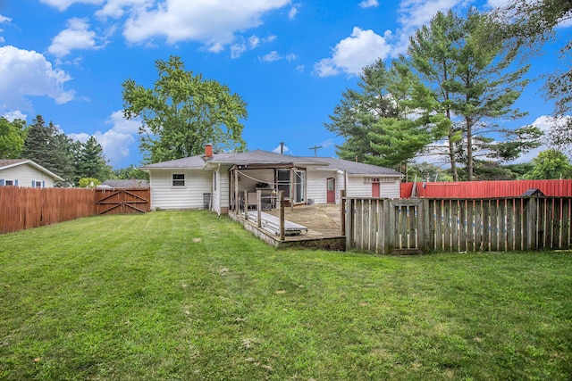 140 Wagon Wheel Ln, Battle Creek, MI 49017 - back of property featuring a fenced backyard, a wooden deck, and a chimney