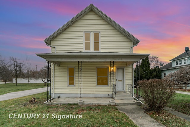 bungalow-style house featuring a yard and a porch