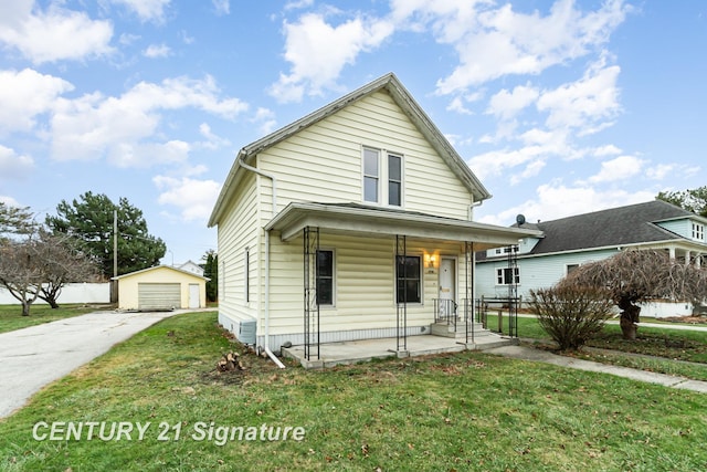 view of front of property featuring a front lawn, covered porch, an outdoor structure, and a garage