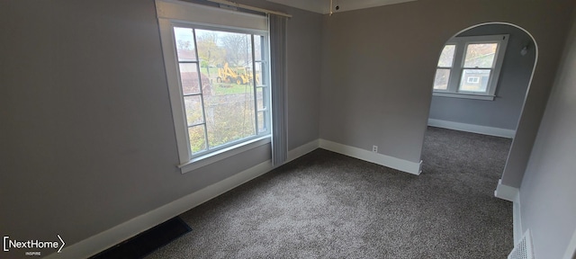 empty room with dark colored carpet