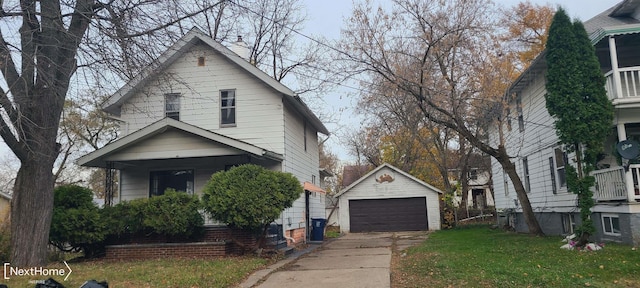 view of front facade with an outbuilding, a front yard, and a garage