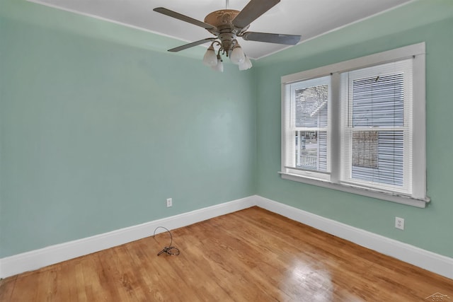 spare room with hardwood / wood-style floors and ceiling fan