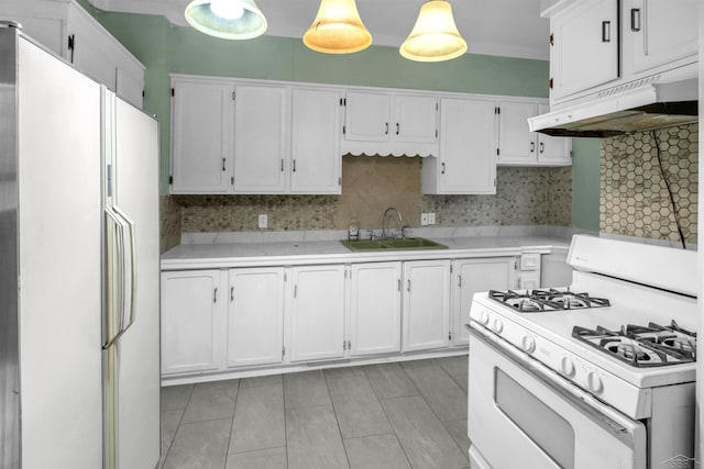 kitchen with decorative backsplash, white appliances, sink, decorative light fixtures, and white cabinetry