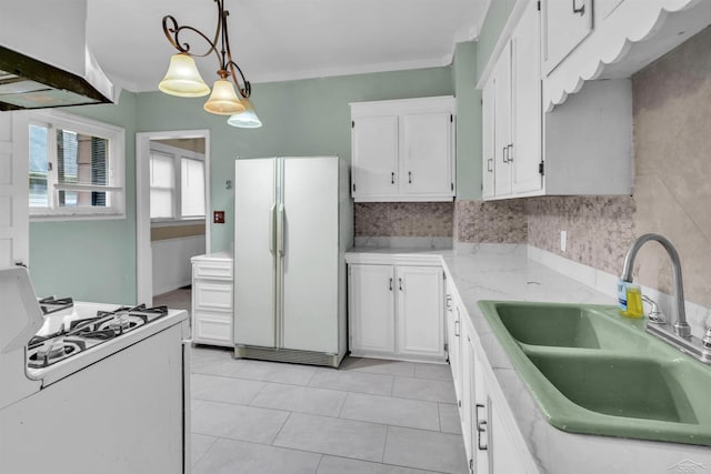 kitchen with sink, white cabinets, pendant lighting, white appliances, and light tile patterned flooring