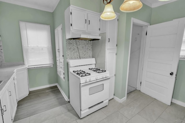 kitchen featuring tasteful backsplash, white range with gas cooktop, white cabinetry, and pendant lighting