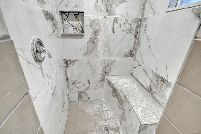 bathroom featuring a tile shower