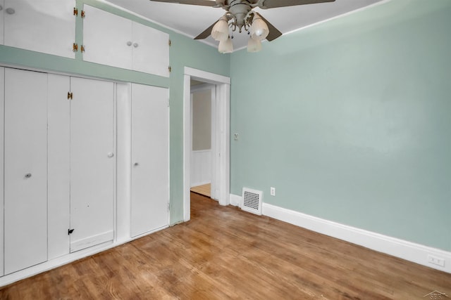 unfurnished bedroom with a closet, light hardwood / wood-style flooring, and ceiling fan