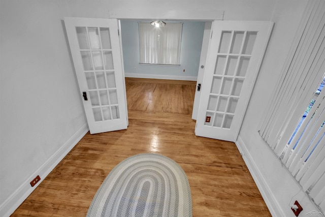 unfurnished dining area with french doors and hardwood / wood-style flooring