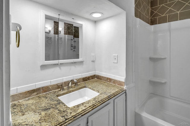 bathroom featuring vanity and washtub / shower combination