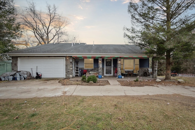 view of front facade with a porch, a garage, and a yard