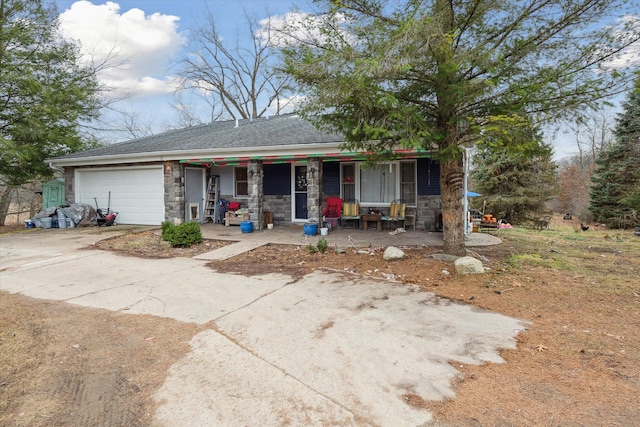 single story home with covered porch and a garage