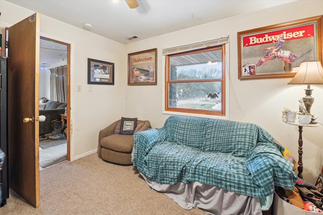 living area featuring ceiling fan and carpet floors