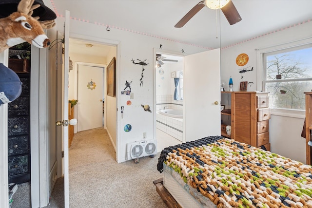 bedroom featuring ensuite bathroom, ceiling fan, and light colored carpet