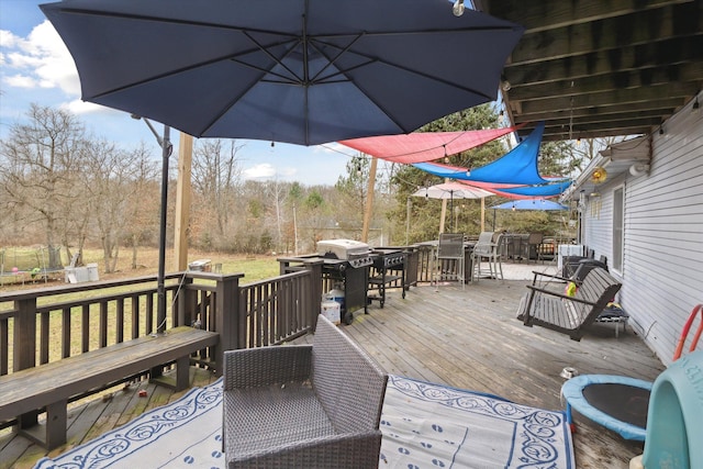 wooden terrace featuring area for grilling