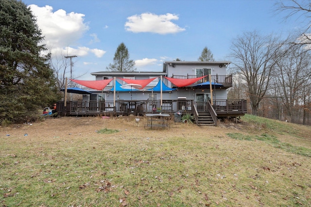 rear view of house featuring a lawn and a wooden deck