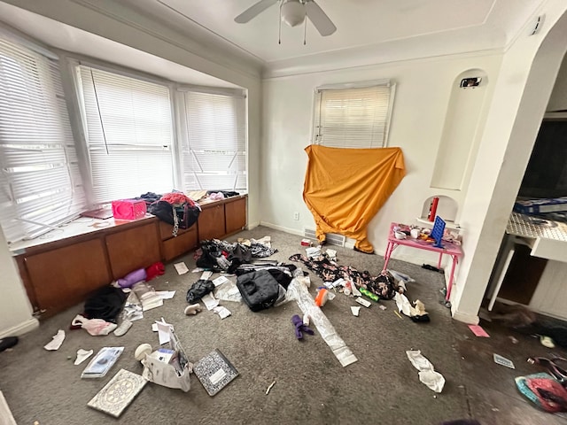 misc room featuring carpet, ceiling fan, a healthy amount of sunlight, and ornamental molding