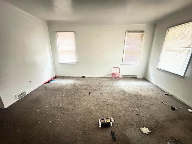 carpeted spare room with crown molding