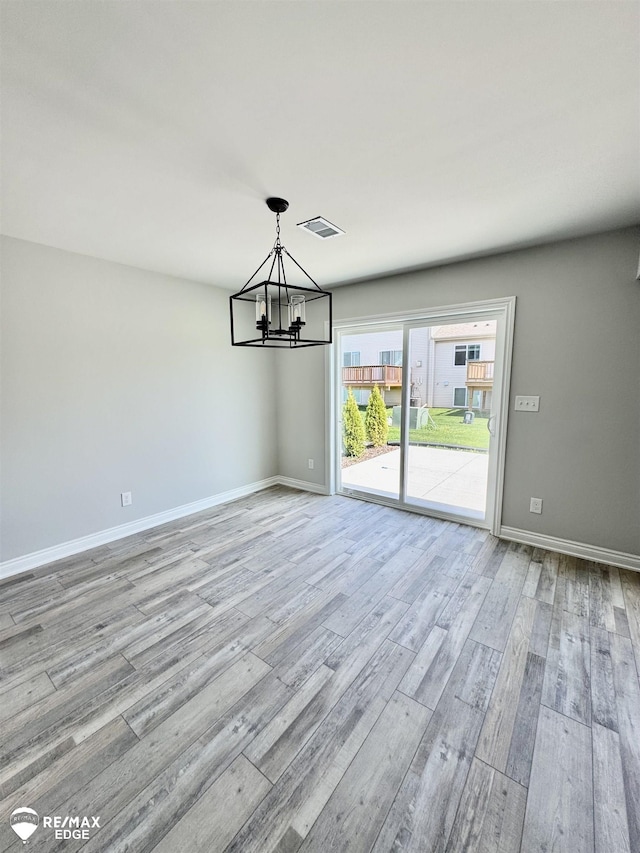 31007 Gregory St, Grand Blanc, MI 48439 - unfurnished dining area featuring visible vents, light wood finished floors, baseboards, and a notable chandelier