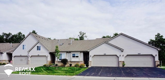 view of front of house featuring a garage and a front lawn