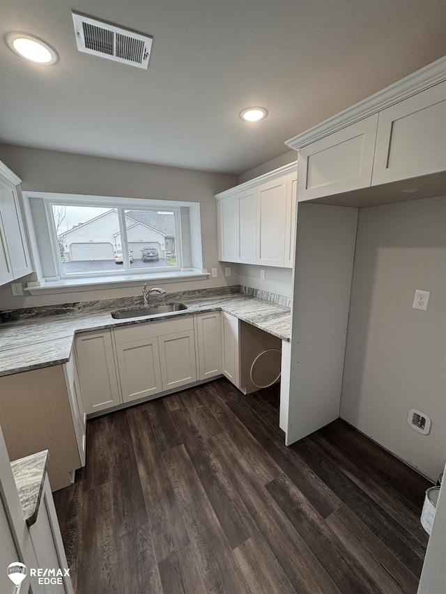 kitchen featuring sink, white cabinets, and dark hardwood / wood-style flooring