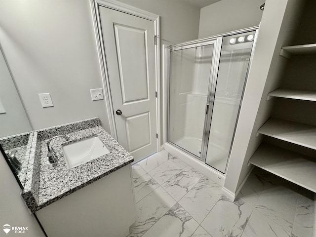 bathroom with vanity and a shower with door