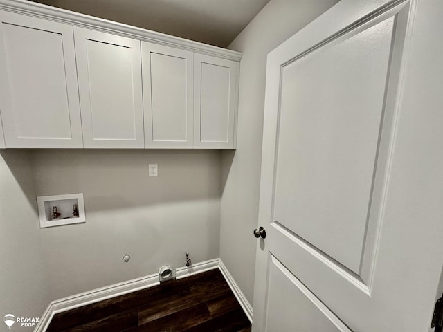 laundry room with hookup for a washing machine, cabinets, dark hardwood / wood-style floors, and hookup for a gas dryer