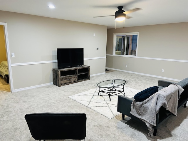 living room featuring ceiling fan and carpet