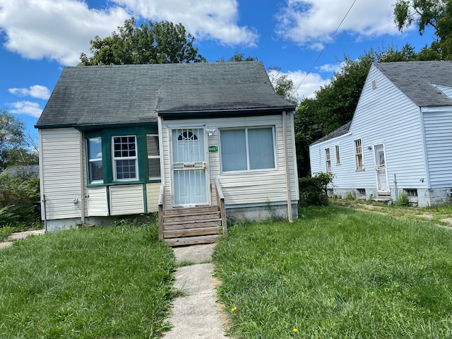 bungalow-style home with a front lawn