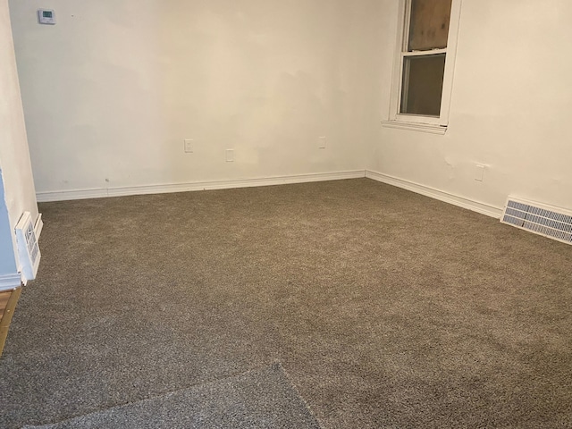 empty room with dark carpet