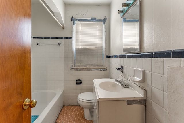 bathroom featuring vanity, toilet, and tile walls