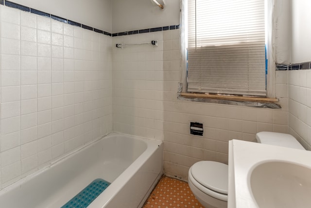 bathroom featuring tile patterned floors, toilet, tile walls, and sink